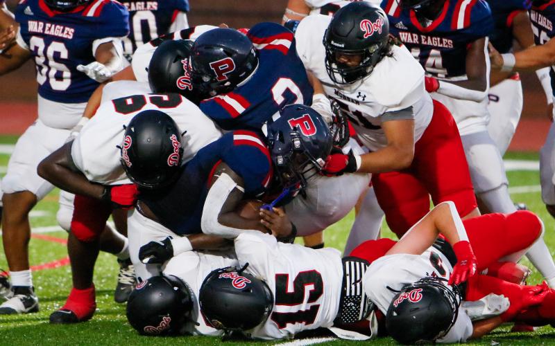 Putnam County running back Rashod Daniel (3) is brought down by a group of Morgan County defenders in a game earlier this season. (LANCE MCCURLEY/Staff)
