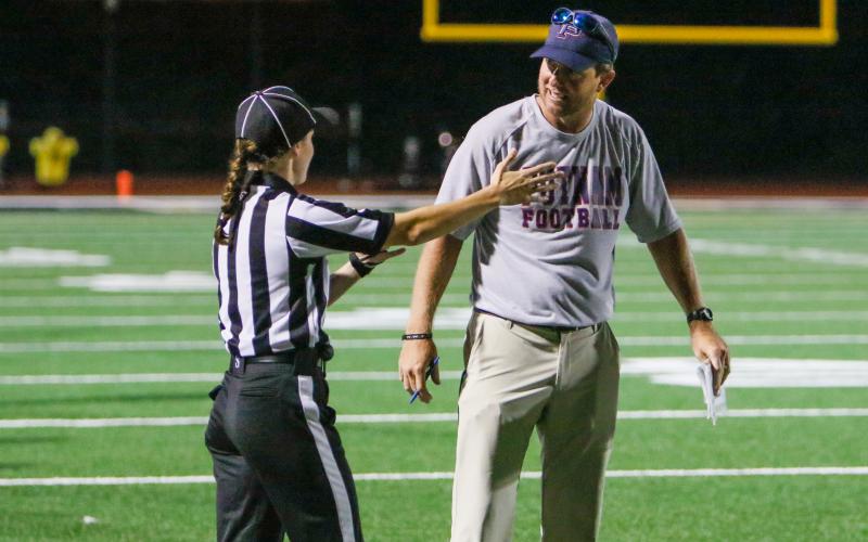 Putnam County head coach Joel Harvin (right) talks to a referee about a call in a game against Greene County earlier this season. FILE PHOTO