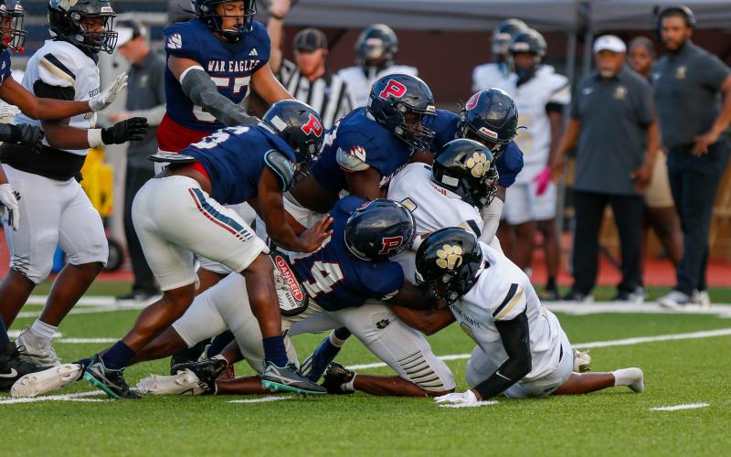A pack of Putnam County defenders swarm a Greene County ball carrier in last week's 42-15 win over the Tigers. LANCE MCCURLEY/Staff