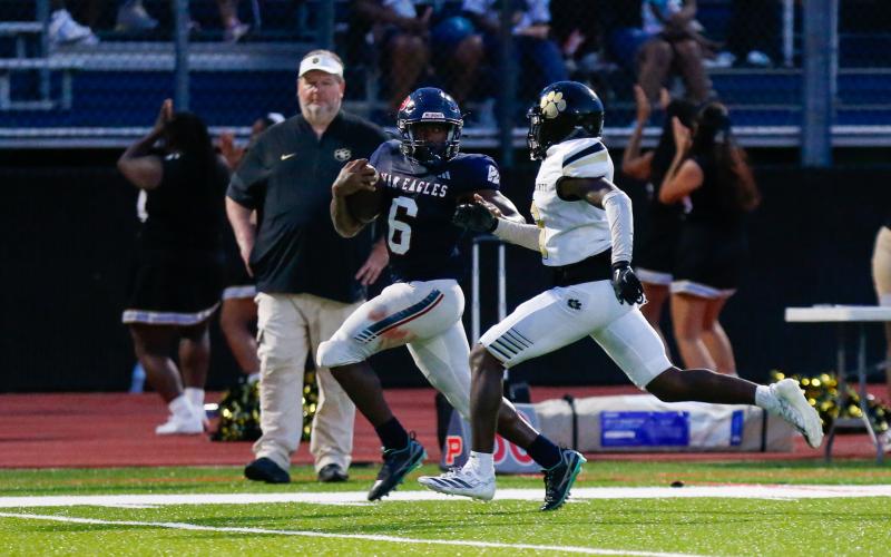 Putnam County senior running back Omarion Butts (6) runs past a Greene County defender on his way to the end zone. LANCE MCCURLEY/Staff