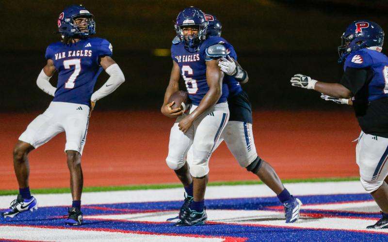 Omarion Butts (6) celebrates with his teammates after scoring a touchdown in Friday's game against Greene County. LANCE MCCURLEY/Staff