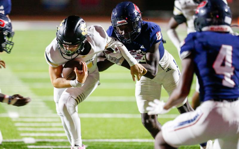A Putnam County defender brings down Greene County quarterback Landon Garretson short of the goal line in the fourth quarter of last week's rivalry matchup. LANCE MCCURLEY/Staff