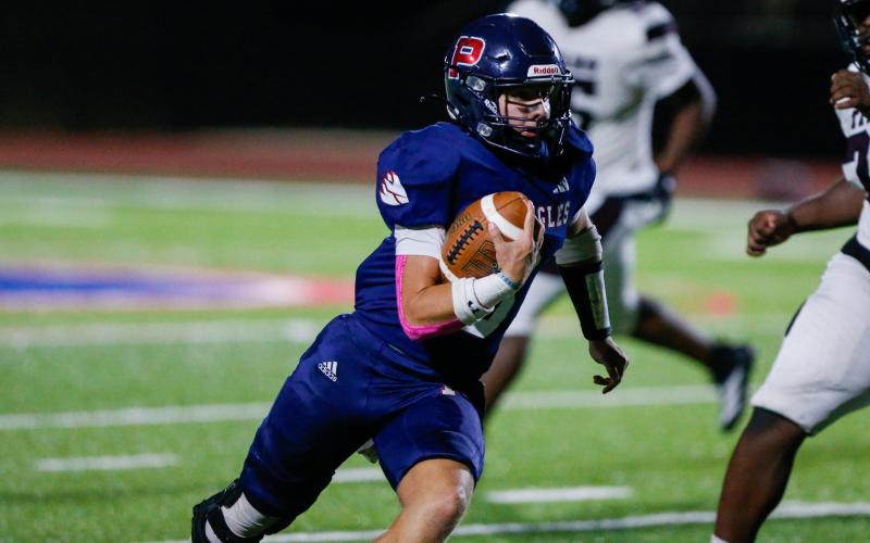 Griffin scrambles downfield past Towers defenders to pick up a first down. LANCE MCCURLEY/Staff