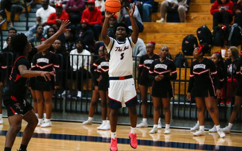 Putnam County’s J’mari Green (3) attempts a shot from beyond the arc in a win over Morgan County on Nov. 20. LANCE McCURLEY/Staff