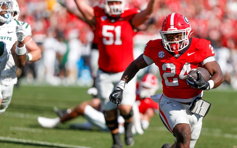 Freshman running back Bo Walker (24), playing his first meaningful minutes for Georgia, made the time count with three touchdowns in a 35-3 rout of Charlotte. LANCE McCURLEY/Staff