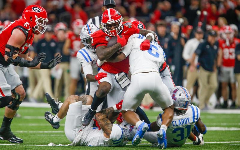 Georgia running back Nate Frazier (3) tries to run over an Ole Miss defender during the Sugar Bowl in New Orleans. LANCE MCCURLEY/Staff