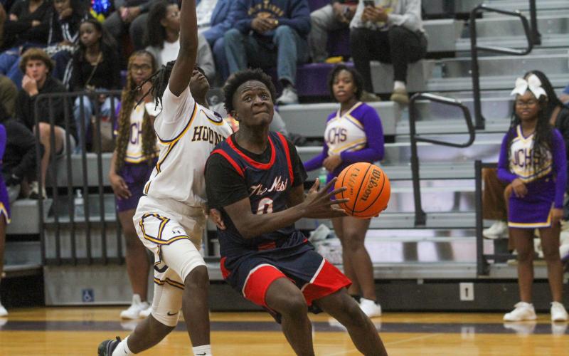 Putnam County senior Tamaud Woodson (0) attempts to go up for a layup against a Jones County defender inside the paint in a loss to the Greyhounds on Jan. 3. BRAD HARRISON/Staff