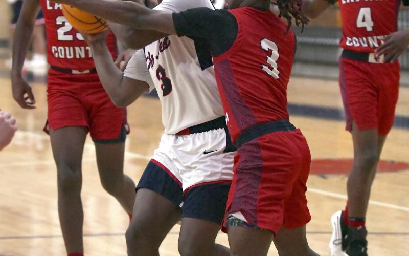 Putnam County senior Jmari Greene (3) gets set to attempt a layup over a defender. IAN TOCHER/Staff
