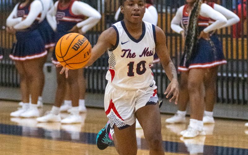 Putnam County guard brings the ball up the floor in a region tournament semifinal game against Jasper County on Feb. 18. SKYLA MORRIS/Staff