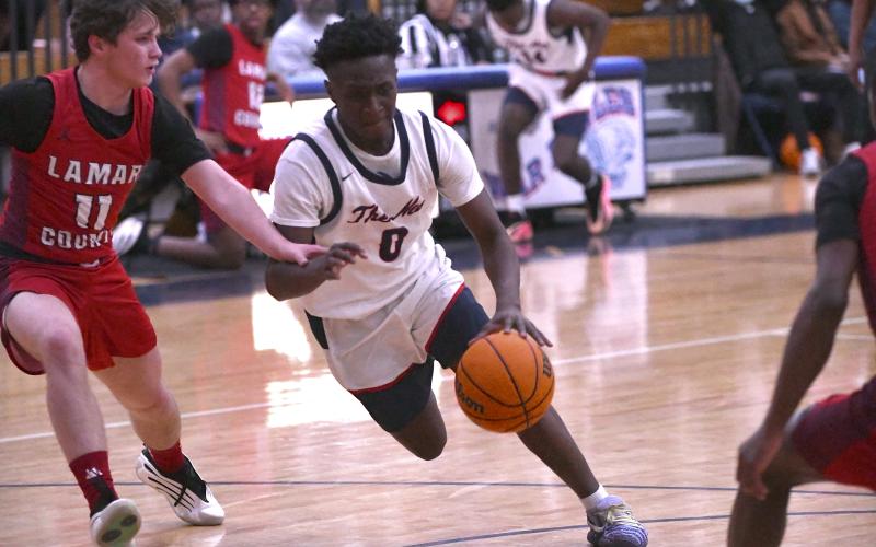 Putnam County senior Tamaud Woodson (0) tries to advance the ball past a Lamar County defender. IAN TOCHER/Staff