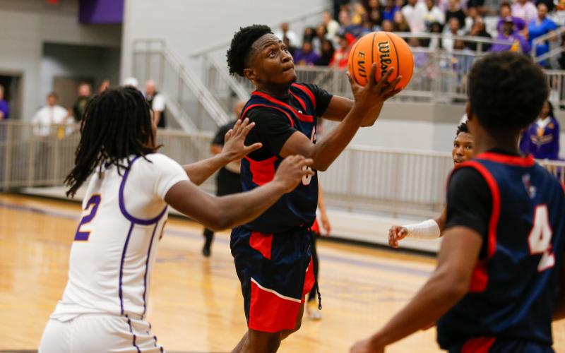 Putnam County senior Tamaud Woodson goes up for a layup over Fitzgerald defenders. LANCE McCURLEY/Staff