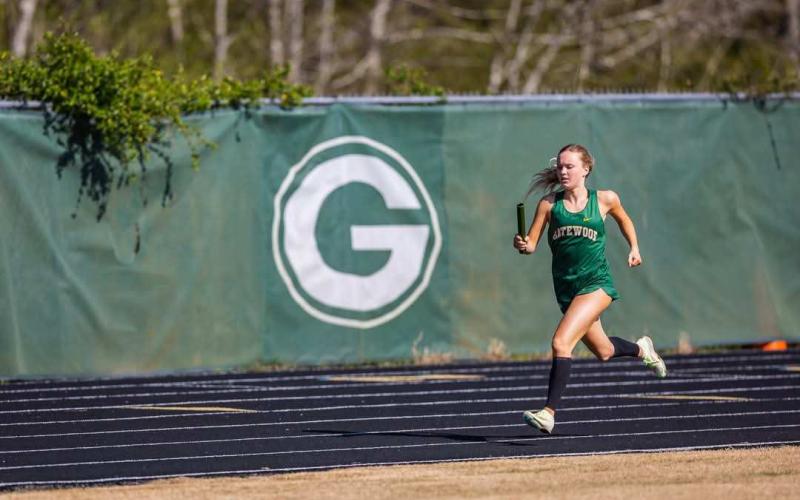 Gatewood senior Presley Moss runs her part of a relay race at a home meet earlier this season. CONTRIBUTED