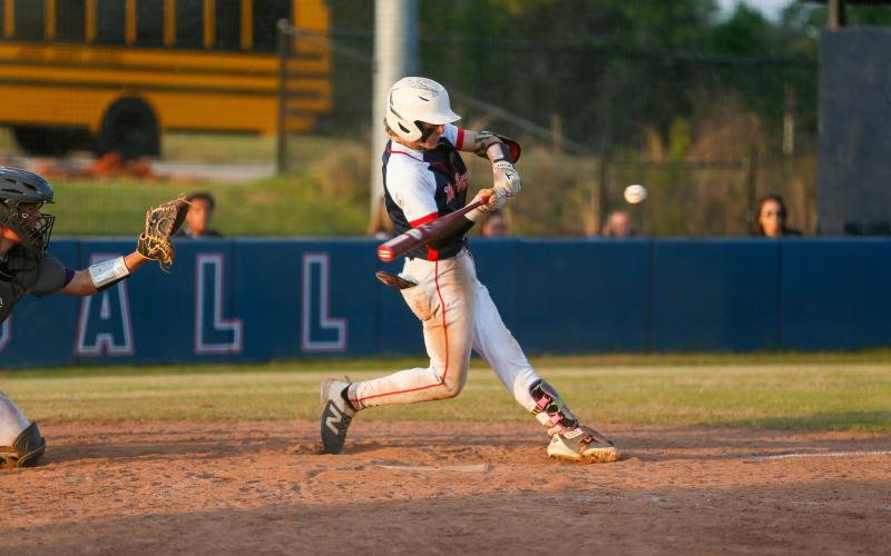 Putnam County senior Gates Lanzarone swings at a pitch, connecting for a key hit. LANCE MCCURLEY/Staff