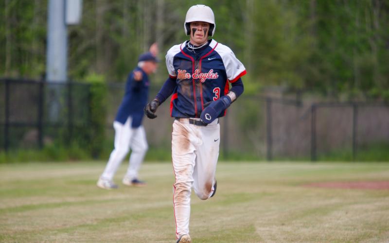 Trace Watkins rounds the bases and scores safely. LANCE MCCURLEY/Staff