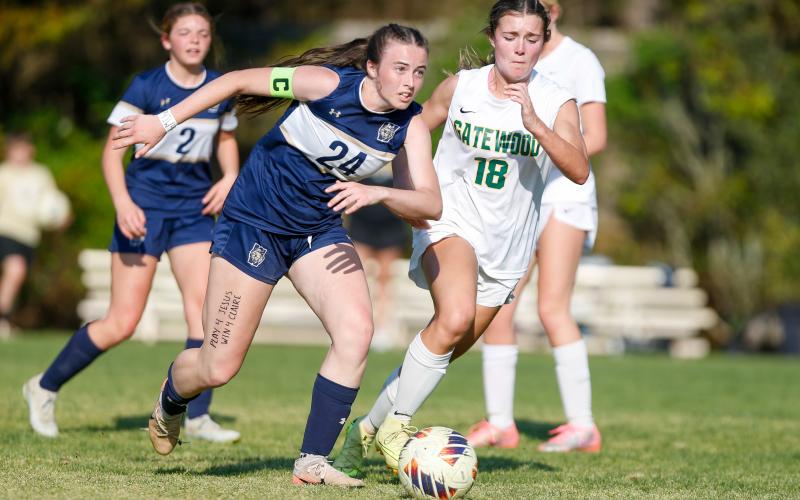 Westminster junior striker Faith Lawhead (24) dribbles the ball past Gatewood senior forward Natalie Sills (18). LANCE McCURLEY/Staff