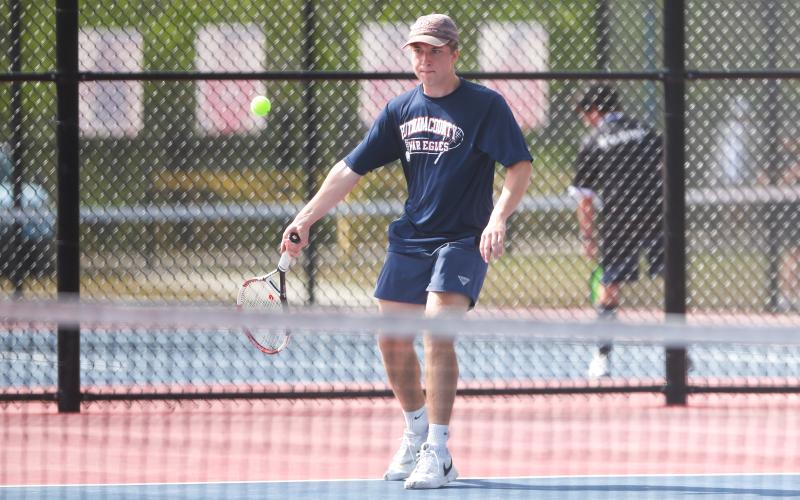 Putnam County's Leland Erickson returns a serve during a match in the region tournament in March. LANCE MCCURLEY/Staff