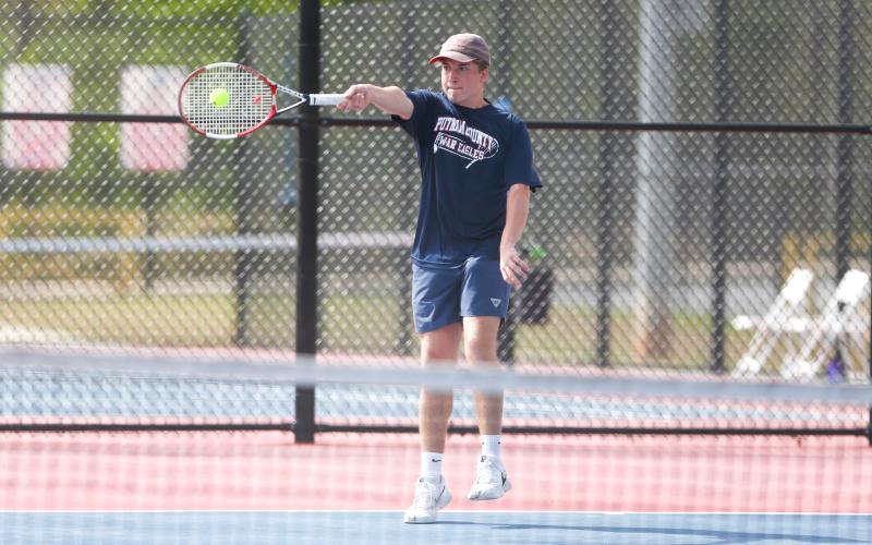 Putnam County’s No. 1 singles player Leland Erickson returns a serve during a volley in Monday’s match against Lamar County. LANCE McCURLEY/Staff