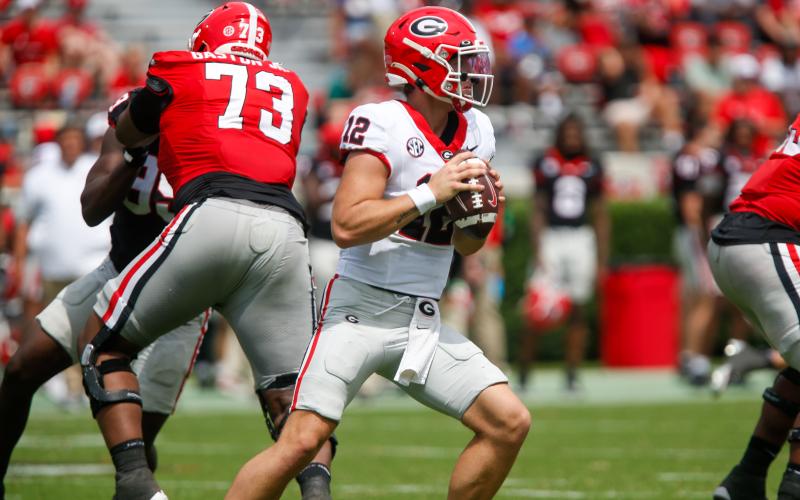 Georgia redshirt freshman quarterback Ryan Puglisi (12) fires a pass downfield during the G-Day scrimmage. LANCE McCURLEY/Staff
