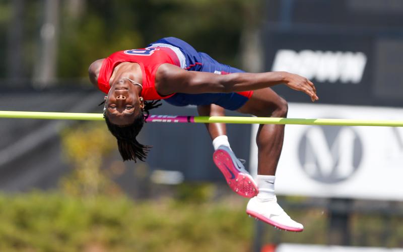 Putnam County senior Bill Waters attempts a jump in the high jump at last week’s region track meet in Social Circle. LANCE MCCURLEY/Staff
