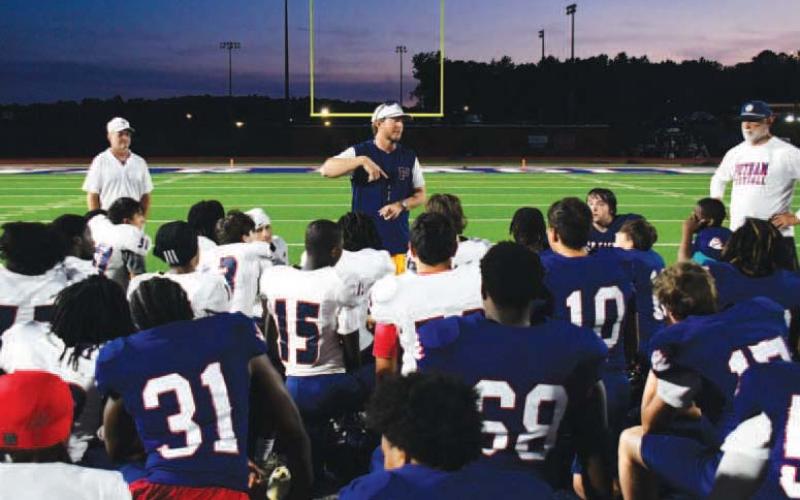 Putnam County High School head football coach Joel Harvin (center) addressed his team following the annual Spring Game to help assess talent and determine positions before the next season begins. IAN TOCHER/Staff