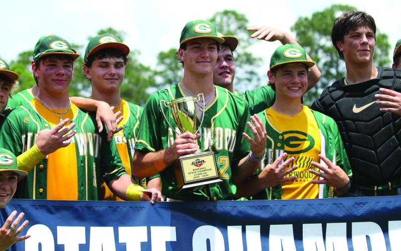 Gatewood players pose with their fourth consecutive state championship trophy last Friday in Statesboro. TREY NORRIS/Staff