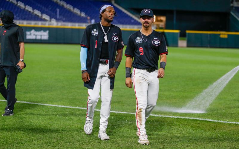 Georgia stars Tre Phelps (1) and Kolby Branch (9) take a lap around Charles Schwab Field following the Bulldogs’ loss to Oklahoma. LANCE McCURLEY/Staff