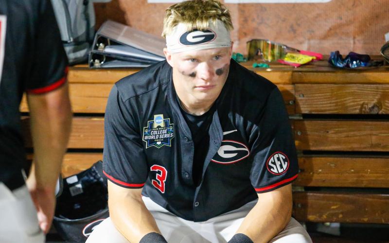 Georgia catcher Daniel Jackson sits in the dugout contemplating what might have been after the Bulldogs’ 11-4 loss to Oklahoma on June 17. LANCE McCURLEY/Staff