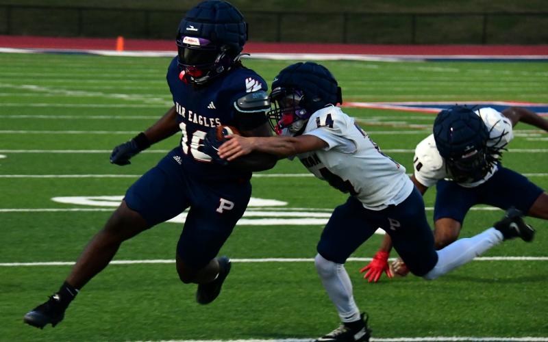 Caption: Putnam County running back Kumari Thomas tries to break a tackle during the team's intrasquad scrimmage on May 15. IAN TOCHER/Staff