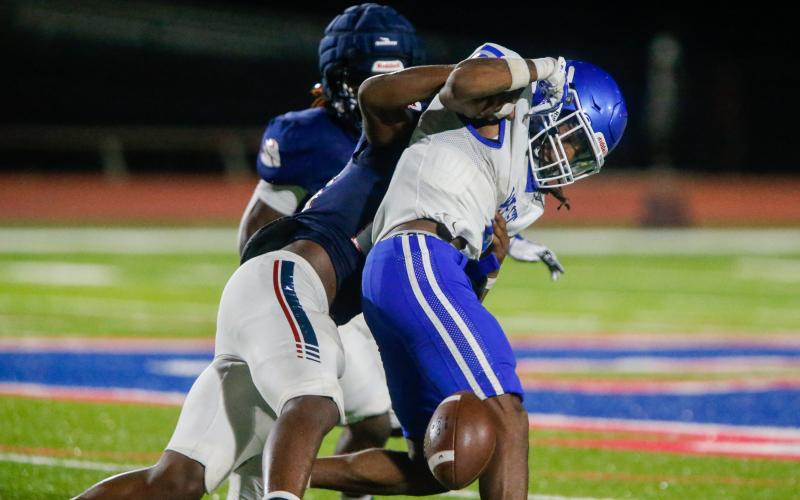 Putnam County's Bryson Brown makes a tackle and forces a fumble during Friday night's 24-21 scrimmage win over West Laurens. LANCE MCCURLEY/Staff