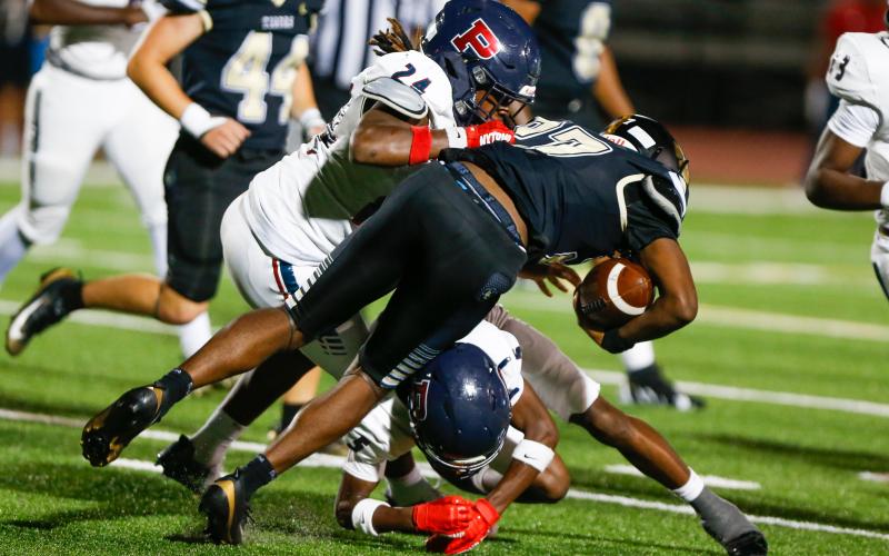 Putnam County senior linebacker Blake Williams (24) brings down a Greene County ball carrier. LANCE MCCURLEY/Staff