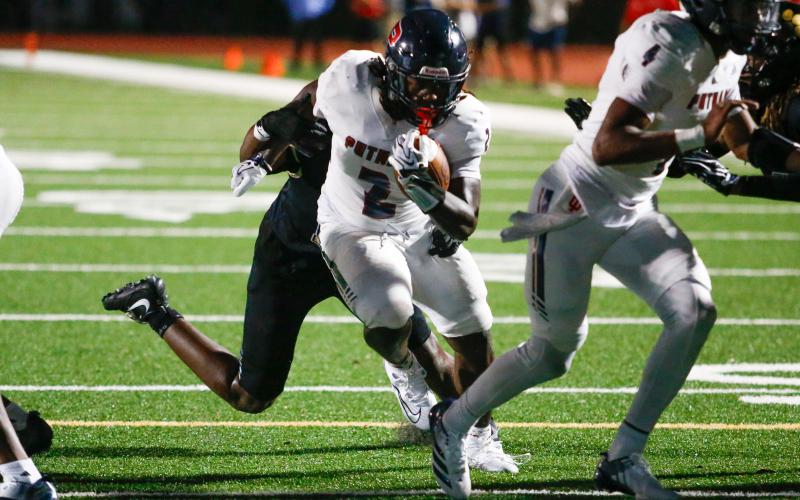 Putnam County junior running back Kumari Thomas (2) shrugs off a Greene County defender as he crosses the goal line for his second touchdown of the game. LANCE MCCURLEY/Staff
