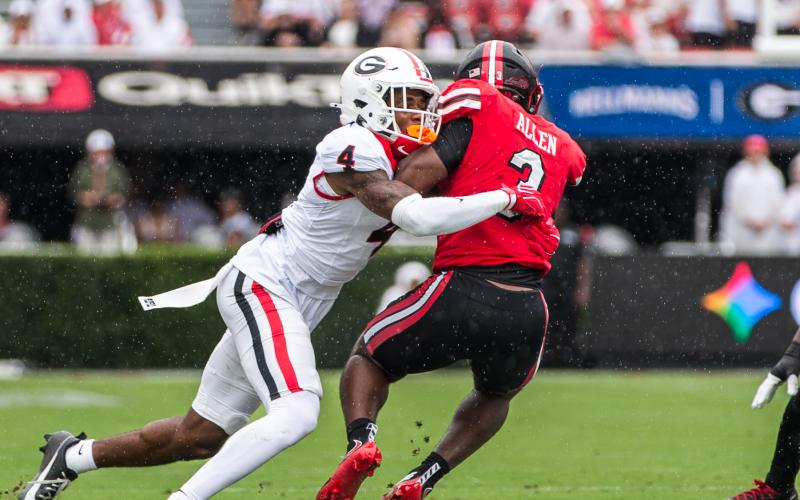 Georgia defensive back KJ Bolden takes down Western Kentucky’s Ajay Allen on the way to the Bulldogs’ 70-20 win. SKYLA MORRIS/Staff