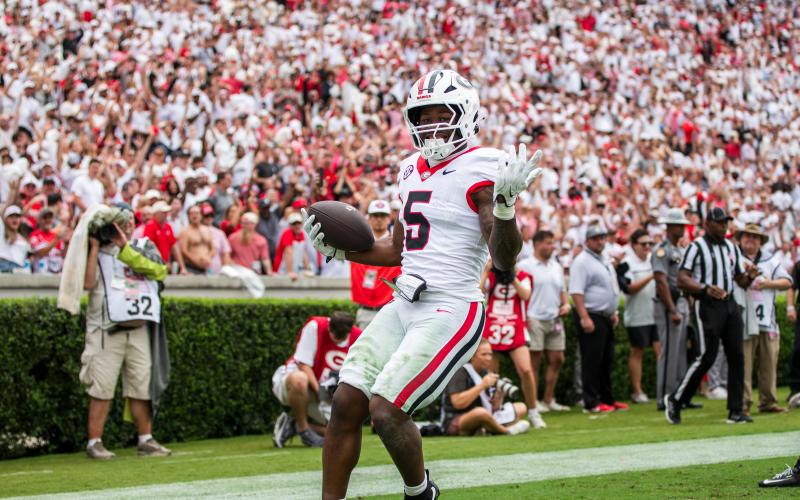 Chauncey Bowens (5) celebrates after hurdling into the end zone for a first-half touchdown. SKYLA MORRIS/Staff