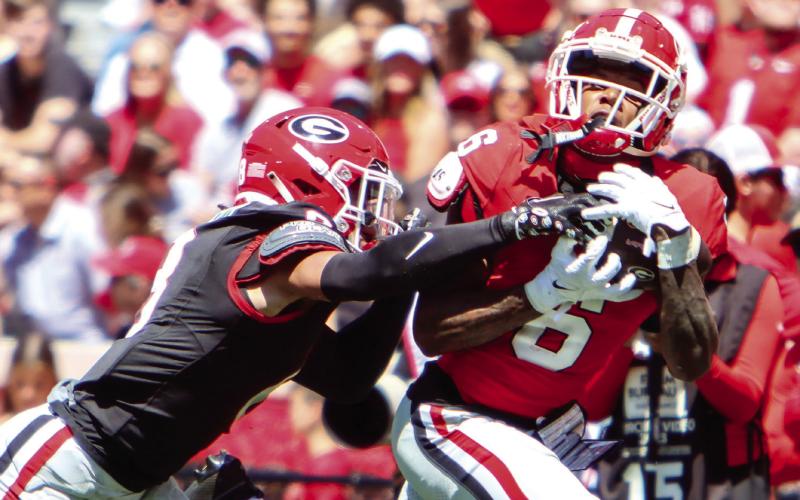 Georgia wide receiver Dominic Lovett (6) makes an over-the-shoulder catch over a defender. (LANCE MCCURLEY/Staff)