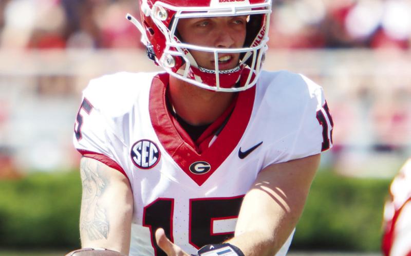 Georgia quarterback Carson Beck (15) takes a snap from the shotgun formation last Saturday in the G-Day game at Sanford Stadium. (LANCE MCCURLEY/Staff)