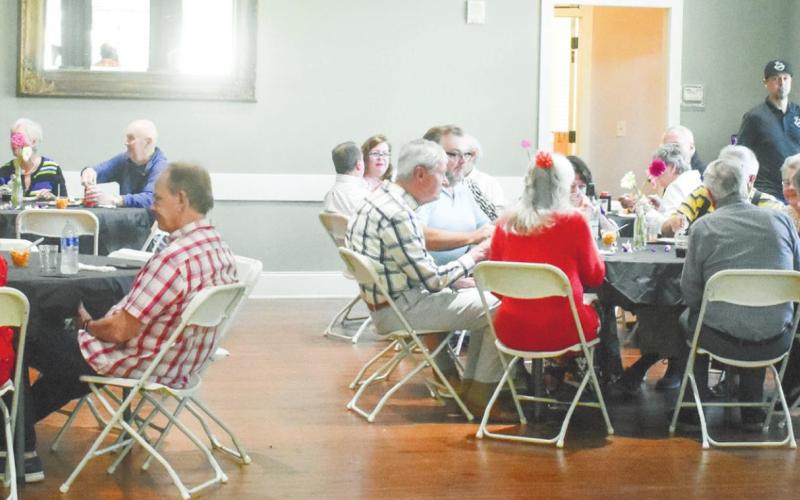 Volunteers enjoy a free meal together, hosted by The Plaza Arts Center, as thanks for their time and dedication to the center. BAILEY BALLARD/Staff