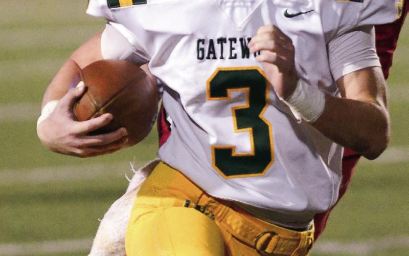 Gatewood running back Jackson Hewatt rushes past defenders during a game last season. (File Photo)