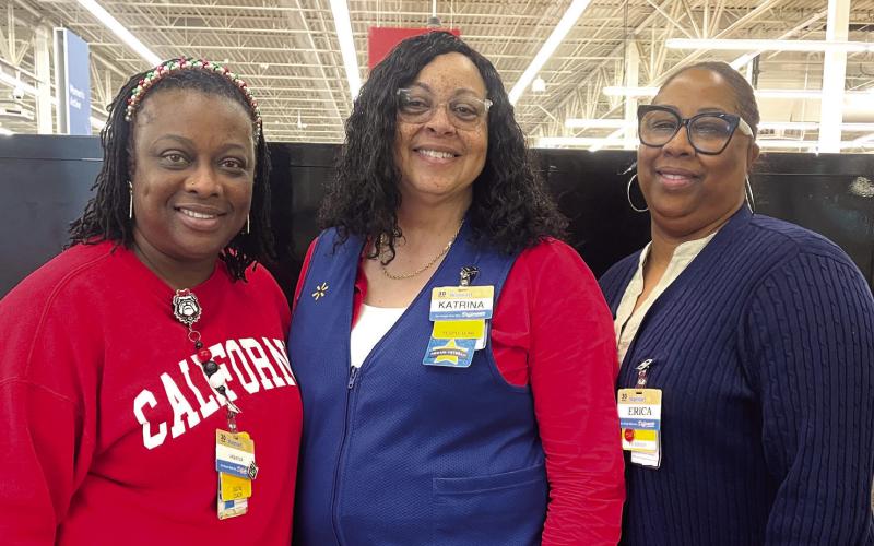 Eatonton Police Chief Howell Cardwell said without these three ladies, Walmart, and donations from the community, Shop with a Cop would not be possible. Pictured are, from left, Walmart’s digital coach Laquesia Waller, HR manager Katrina Palmer, and front-end coach Erica Williams, who were instrumental in organizing the evening. LYNN HOBBS/Staff