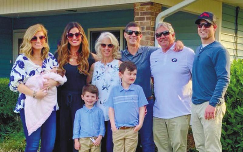 The Stephens family poses in front of the renovated St. Mary’s Mercy Guest Cottage at Highland Hills Village shortly after the blessing ceremony on March 30. CONTRIBUTED