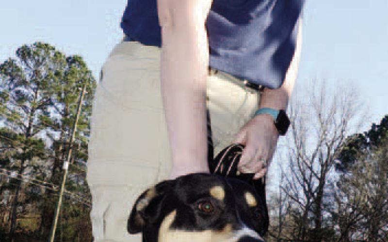 Animal tech Ashley Moran takes “Bernard,” a happy, energetic pup, for a short walk outside the Putnam County Animal Services building.