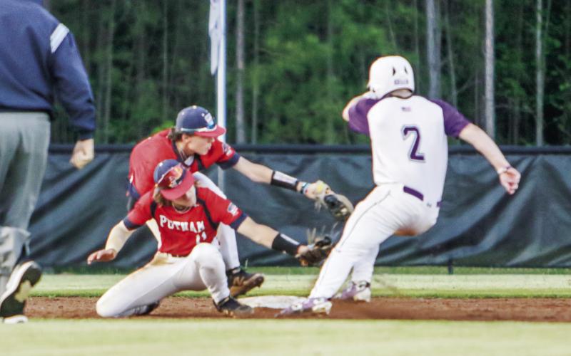 Putnam County shortstop Gates Lanzarone (11) applies the tag to a Jasper County baserunner, who was initially ruled out, while colliding with teammate and second baseman Trace Watkins. The call was then overturned, leading to the runner scoring to secure the Hurricanes the win during the next at-bat. LANCE McCURLEY/Staff