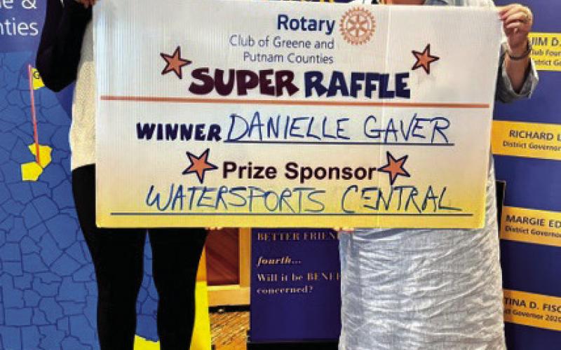 Rotarians Destiny McClendon (left) and Jennifer Pennington present an inflatable kayak valued at $300 from prize sponsor Watersports Central to Rotary Raffle Week 29 winner Danielle Gaver, who was unavailable for the photo. CONTRIBUTED