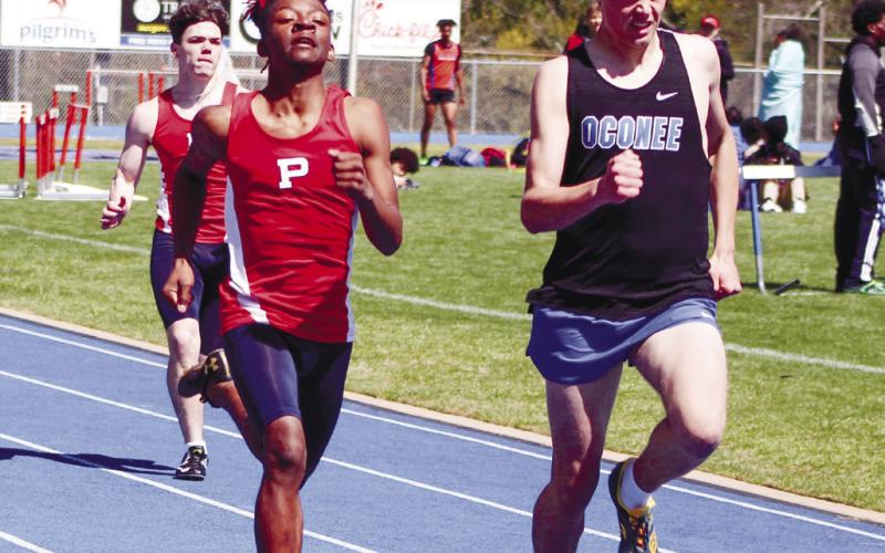 Brandon Brown chases down a runner from Oconee County. ARELLA CASH/Staff