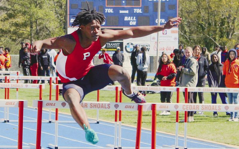 Brayon Farley glides over a hurdle. ARELLA CASH/Staff