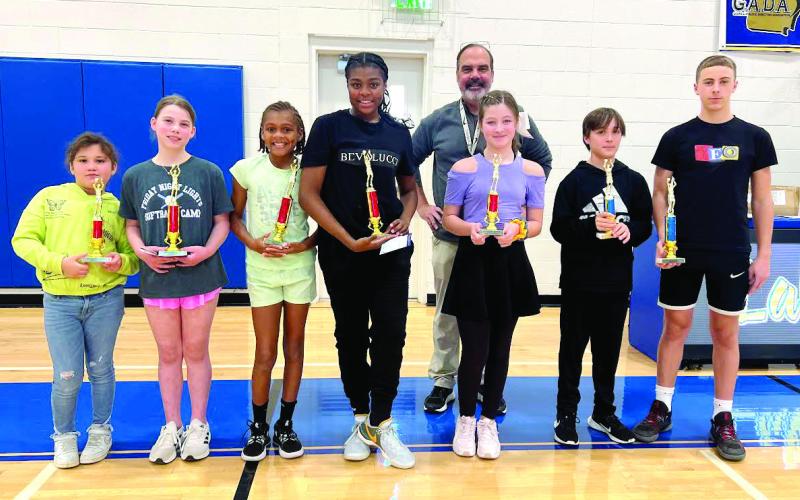 Shown (l-r) are Zaydi Lazaro who placed second in 8 &amp;amp; 9 girls; Julianna Zweig, first for 8 &amp;amp; 9 girls; Journey Mincey, winner for 10 &amp;amp; 11 girls; Jermane Mincey, winner for 12 &amp;amp; 13 girls; Vail McMillan, runner-up in 12 &amp;amp; 13 girls; Harrison Scouten, second for 12 &amp;amp; 13 boys; and Carson Williams, first for 12 &amp;amp; 13 boys; with Lake Oconee Elks Lodge Hoop Shoot Chairman Jamie Grill in the back. No contestants entered for 8 &amp;amp; 9-year-old boys. CONTRIBUTED
