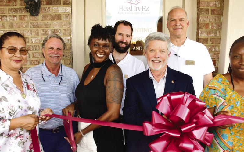 Latonya Taylor (third from left) prepares to cut the ribbon to officially open her Heal In-Ez Reiki &amp;amp; Wellness Spa Aug. 5, in a ceremony hosted by the Eatonton-Putnam Chamber of Commerce. IAN TOCHER/Staff