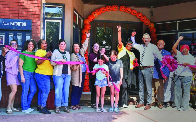 A large group of local well-wishers, including Eatonton Mayor John Reid (4th from right) and his wife Janie (far left), joined several other downtown business owners in welcoming Toys for Tots to a ribbon-cutting ceremony in front of the Eatonton-Putnam Chamber of Commerce offices on East Marion Street. CONTRIBUTED