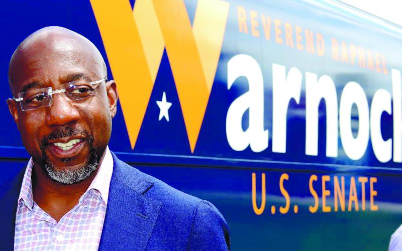 IAN TOCHER/Staff Sen. Raphael Warnock rolled into town Aug. 18 and spent a few minutes in front of Eatonton’s historic court house before giving a speech at nearby Ebenezer Baptist Church.