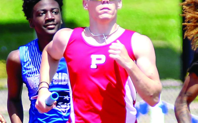 Putnam County’s Aiden Chaffin runs a leg of the 4x400-meter relay race. TREY NORRIS/Staff
