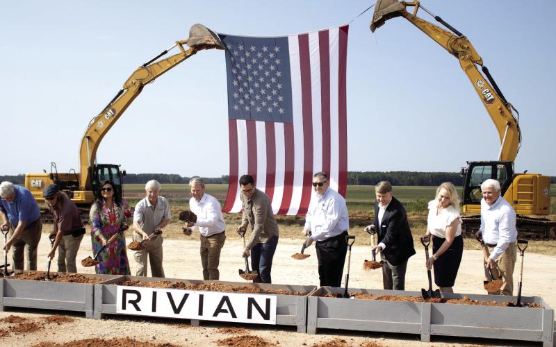 Rivian founder and CEO RJ Scaringe (third form left), with Georgia Gov. Brian Kemp to the right, break ground on the Stanton Springs project site in Social Circle, alongside several other state and local representatives. SKYLA MORRIS/Staff